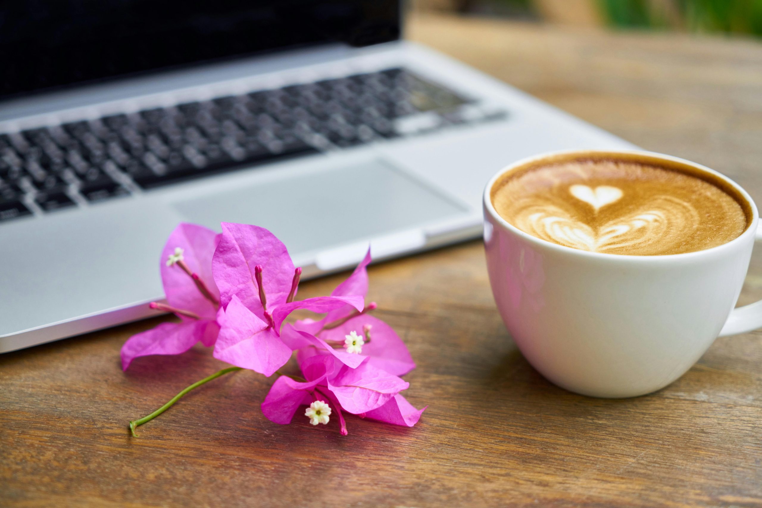 White Ceramic Teacup Beside Laptop